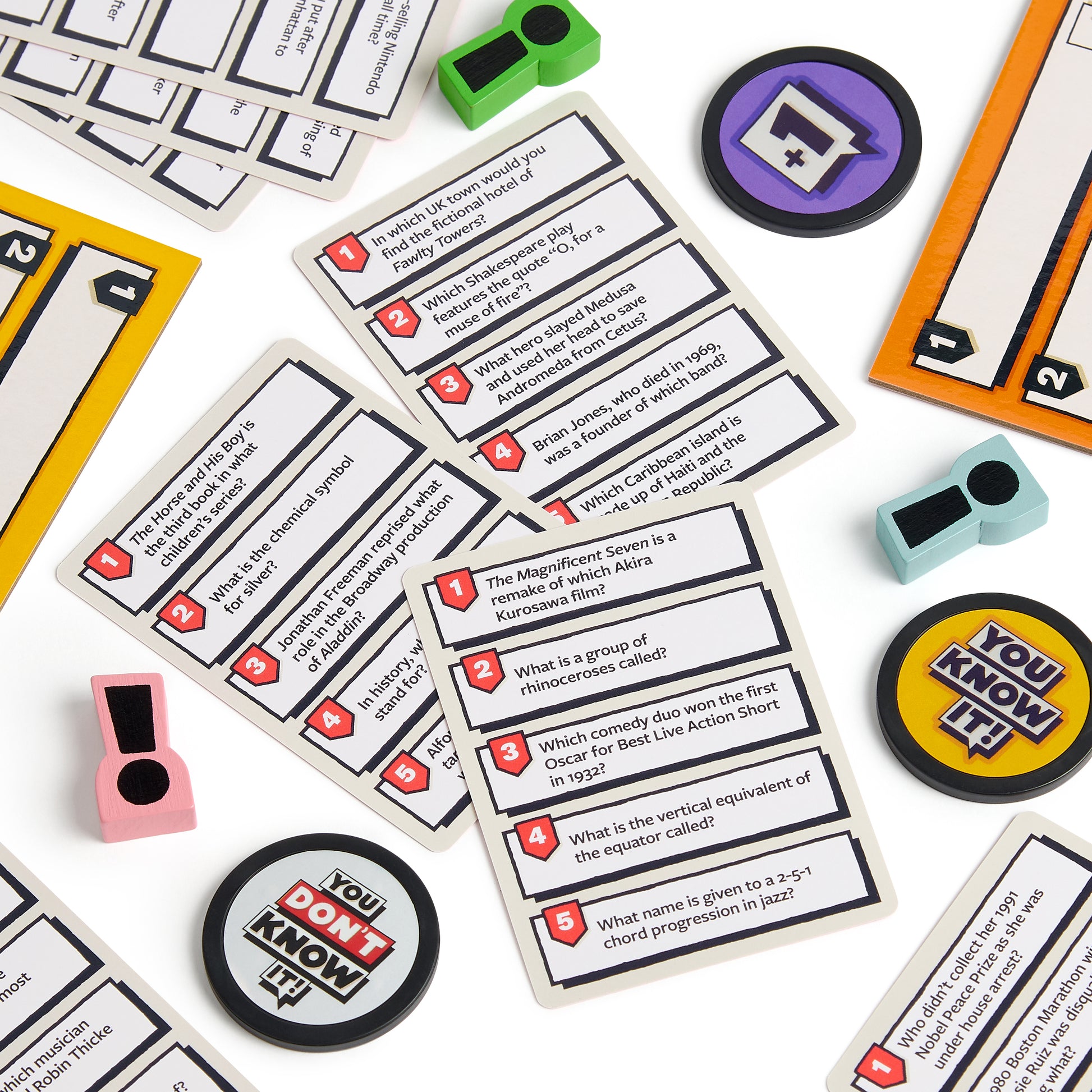 Card game components including question cards and character tokens on a white background